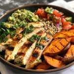 Grilled herb chicken bowl with vibrant sweet potato fries and fresh avocado salsa.