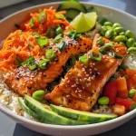 Close-up view of a Healthy Sweet Chili Salmon Bowl with colorful vegetables.