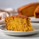 Close-up of a Flourless Sweet Potato Ginger Cake with a golden-brown crust and a moist interior.