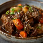 Close-up of a healthy crock pot dish featuring Korean beef, garnished with green onions and sesame seeds.