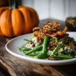 Close-up of a rich Green Bean Casserole topped with crispy onions.