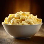 Close-up of creamy Crockpot Mac and Cheese with melted cheese on top.