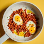 Close-up of Chickpea Fried Eggs garnished with parsley, showcasing a golden brown texture.