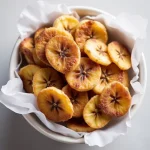Close-up of crispy cinnamon banana chips arranged neatly, showcasing their texture.