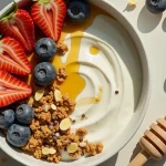 Close-up of a Greek Yogurt Breakfast Bowl topped with granola and mixed berries.