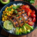 Close-up of a Honey Chipotle Chicken Rice Bowl with diced chicken, avocado, and cilantro.