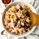 Close-up of creamy Crockpot Fiesta Chicken with colorful toppings.