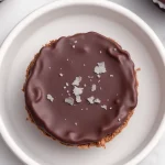 Close-up of no bake peanut butter oat cups with a textured surface and chocolate chips.