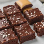 Close-up of moist low-calorie brownies made with Greek yogurt, topped with chocolate chips.