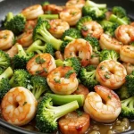 Close-up of sautéed shrimp and broccoli with garlic and lemon.