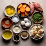 A close-up of a vibrant bowl filled with diced chicken, roasted sweet potatoes, and fresh greens.