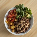 Close-up of a High Protein Burger Bowl with lean ground beef, spinach, and colorful vegetables.