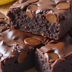Close-up of a moist brownie made from bananas, cocoa powder, and nut butter, with a soft background.