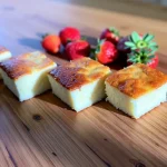 Close-up of a sugar-free yogurt cake, showcasing its moist texture with a warm light background.