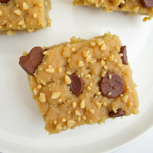Warm banana bars with chunks of nuts, presented in soft natural light.