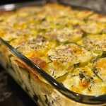 Close-up view of a deliciously baked Bisquick Zucchini Casserole, featuring a golden crust and visible zucchini pieces.