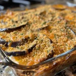 Close-up view of a slice of Southern Eggplant Casserole, showcasing its creamy texture and golden crust.