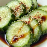 A vibrant bowl of easy Asian cucumber salad with sesame seeds and cilantro