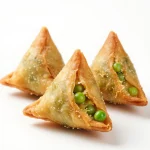A plate of golden brown gluten free samosa patties garnished with fresh cilantro
