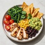 A vibrant Southwest salad topped with colorful vegetables and a creamy homemade dressing